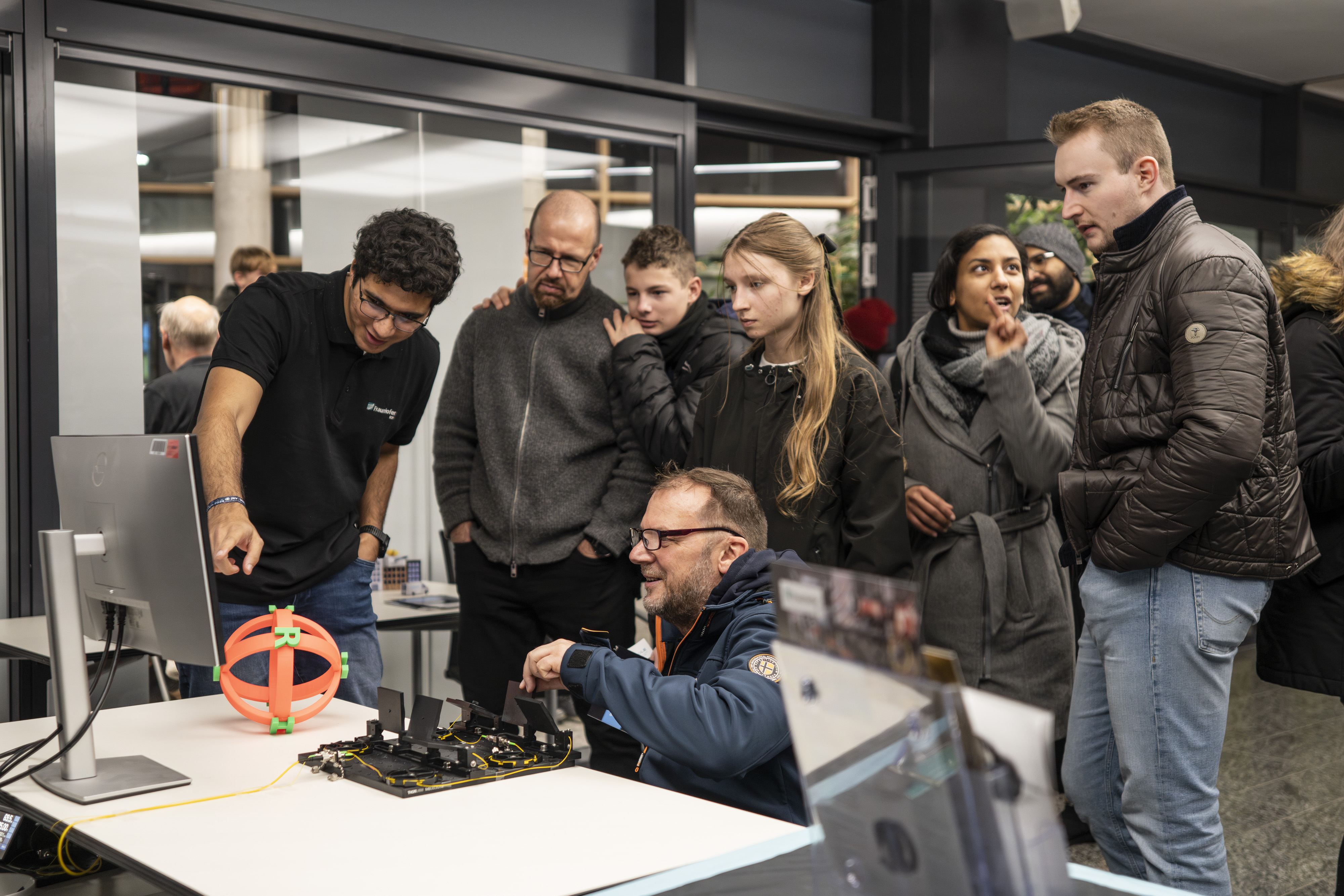 A group of people in front of a computer