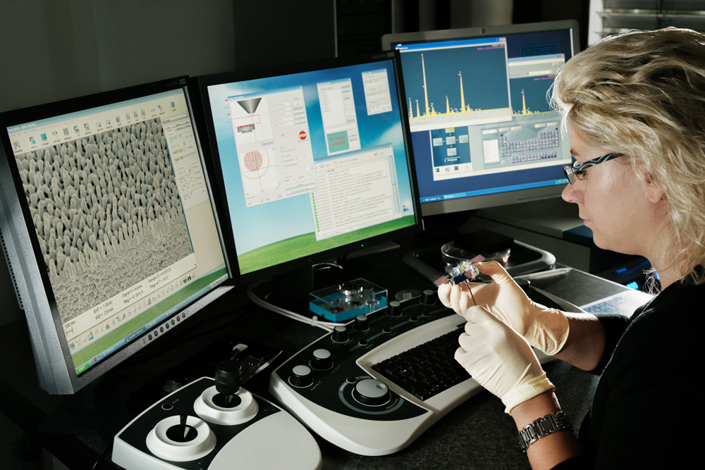 Scientist examines anti-reflective structures using a scanning electron microscope.