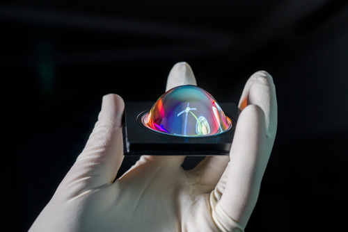 A lens coated with ALD in the hand.