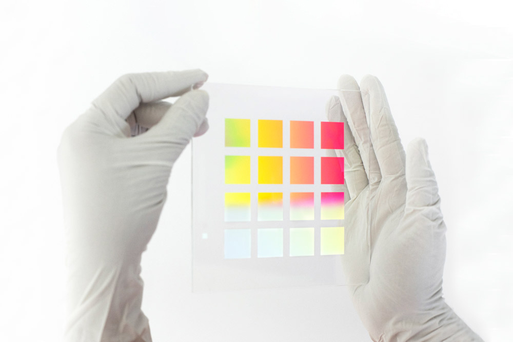 A silicon wafer with diffractive optical gratings in the hands of a researcher.