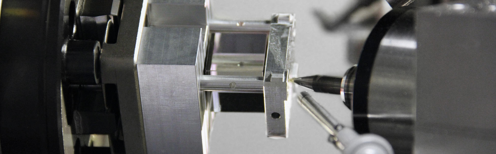 Adjustment milling of a beamsplitter cube assembly.