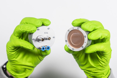 Front and back of a focus mirror in the hands of a researcher.