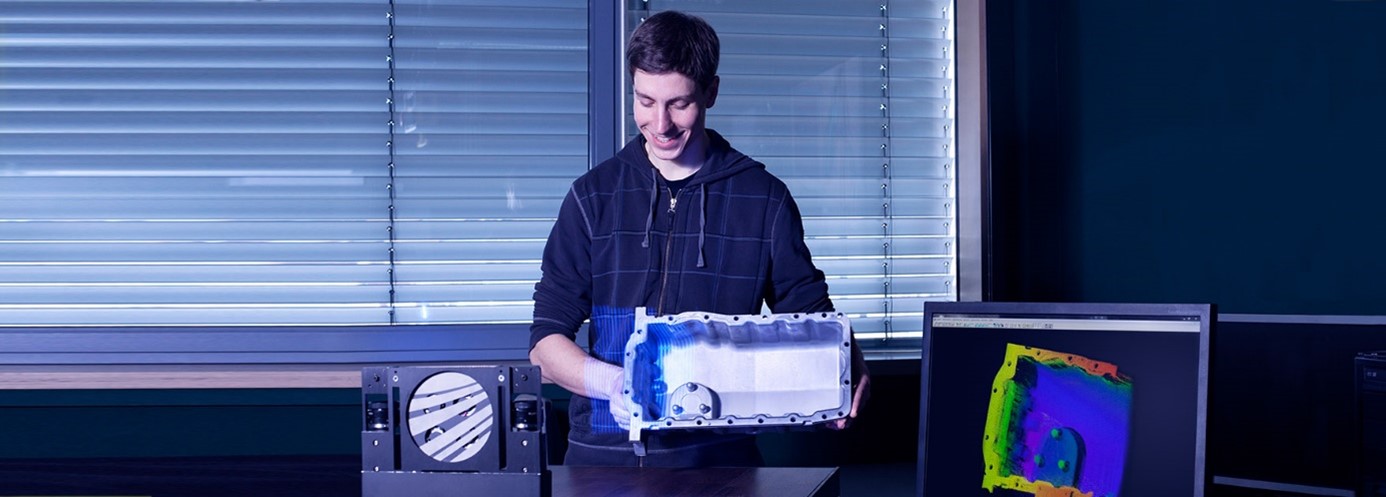 Researcher taking 3D measurements of cast parts in the laboratory.