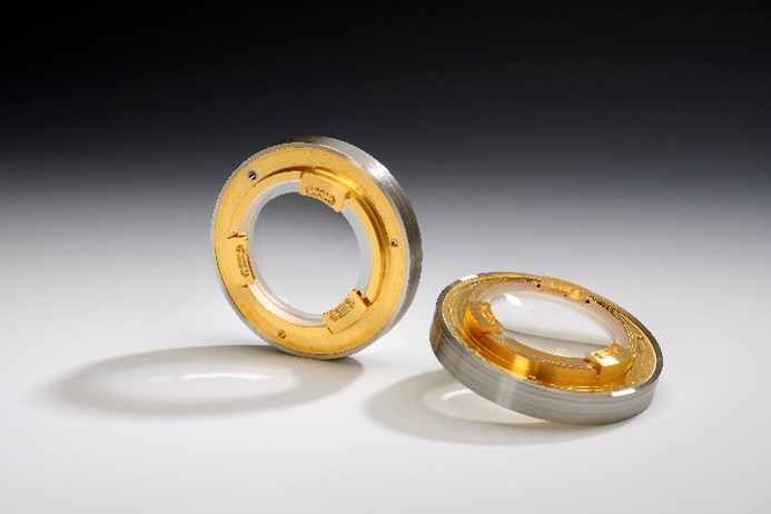 Low-stress soldered lenses for high-performance optics