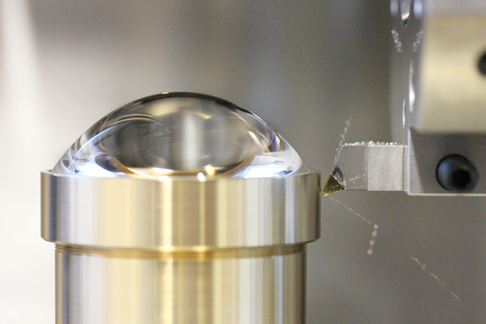 Processing a lens group with the CNC milling machine.