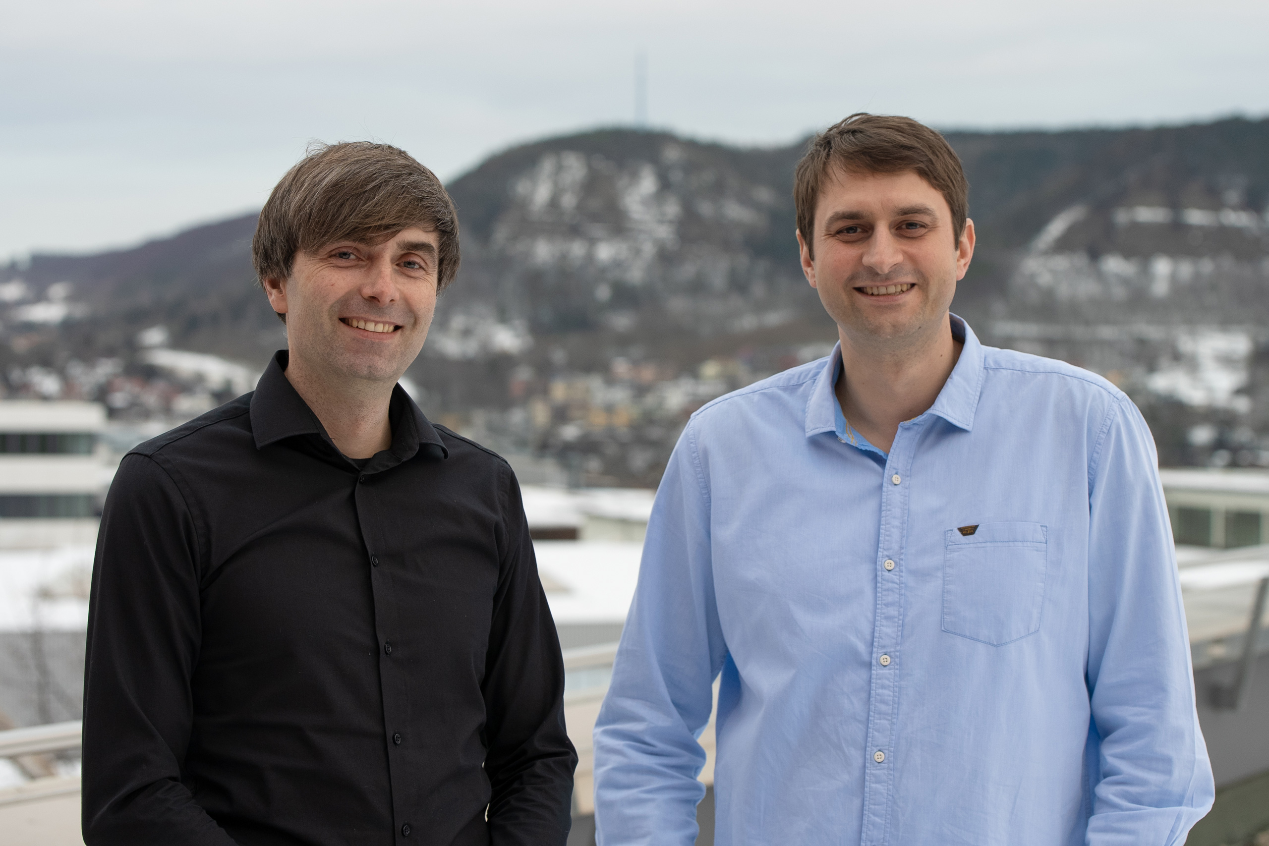 The two researchers in front of the mountains in Jena.