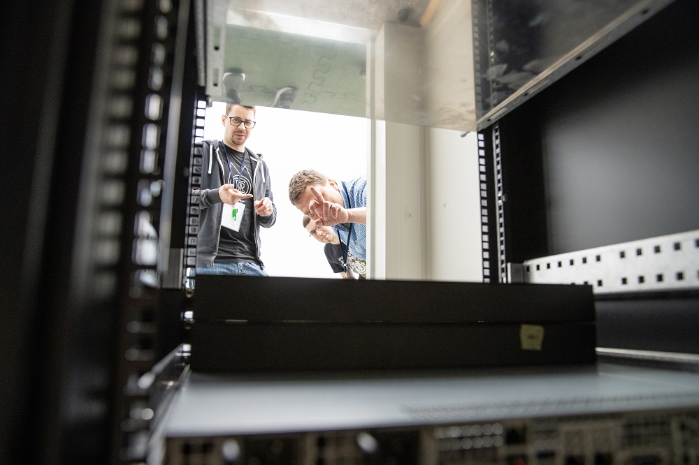 QuNET researchers examine a rack