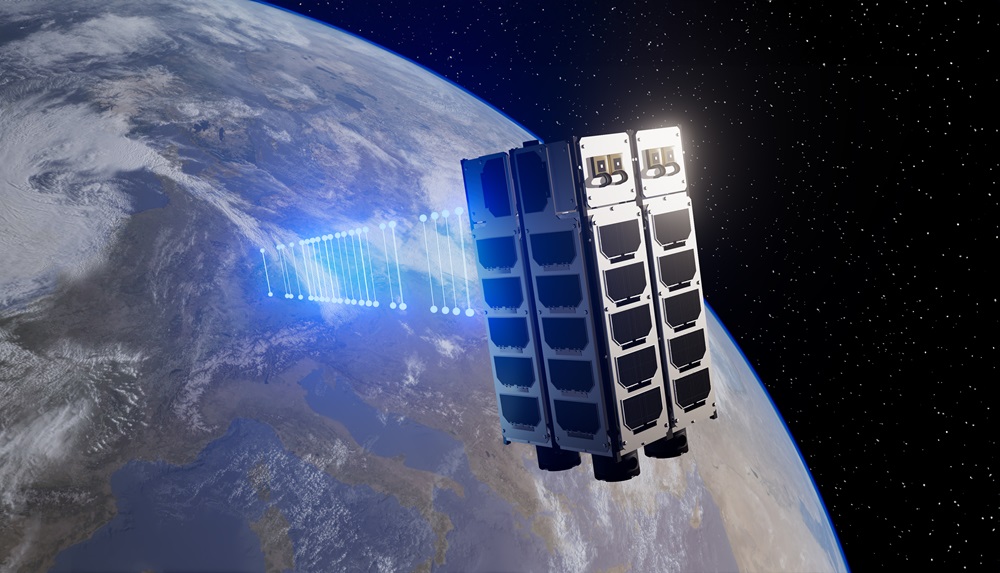 A metal satellite in the shape of a rectangular cube floats in space and directs a beam, visualized in blue, towards the earth. 